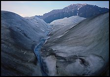 Root Glacier, glacial stream, and mountains at dusk. Wrangell-St Elias National Park, Alaska, USA.