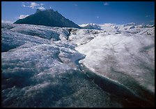 Stream running on surface of Root Glacier and Donoho Peak. Wrangell-St Elias National Park, Alaska, USA.