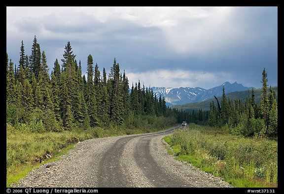 McCarthy road with vehicle approaching in the distance. Wrangell-St Elias National Park, Alaska, USA.