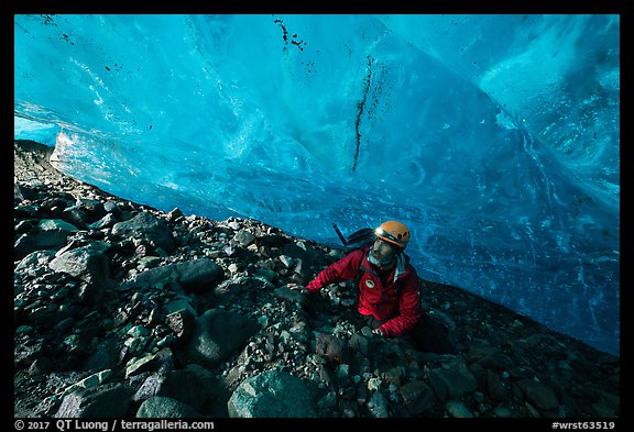 Mountaineer below blue ice cave ceiling. Wrangell-St Elias National Park (color)