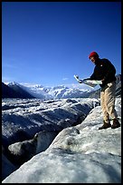 Hiker checks map on Root Glacier. Wrangell-St Elias National Park ( color)