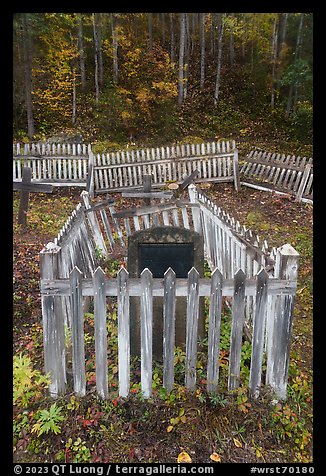 Headstone in grave fenced with white pickets, Kennecott cemetery. Wrangell-St Elias National Park (color)