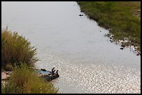 Couple sitting on edge of hot springs seen from above. Big Bend National Park ( color)