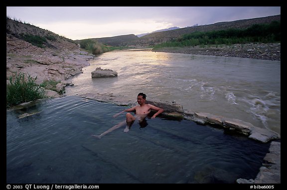 Visitor relaxes in hot springs next to Rio Grande. Big Bend National Park (color)