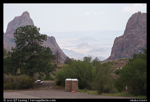 Portable toilets and a picnic table stand at the overlook where the basin opens in a dramatic V-shaped gap to the desert beyond. Big Bend National Park (color)