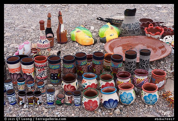 Rows of tall cups, squat vases, and bottle-shaped flasks crowd together on the stony ground. Big Bend National Park (color)
