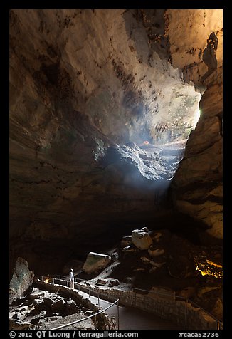 Visitor looking at natural entrance from below. Carlsbad Caverns National Park (color)