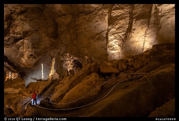 Visitor Looking, massive columns and draperies of stone on natural entrance route. Carlsbad Caverns National Park (color)