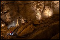 Visitor Looking, massive columns and draperies of stone on natural entrance route. Carlsbad Caverns National Park ( color)