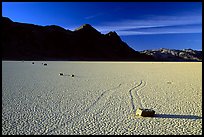 Tracks, moving rock on the Racetrack and Ubehebe Peak, late afternoon. Death Valley National Park, California, USA.