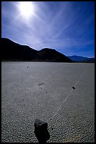 Tracks and moving rock on the Racetrack, mid-day. Death Valley National Park, California, USA.