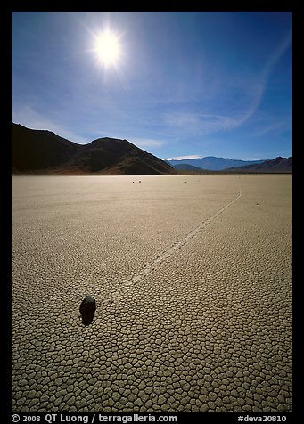 Tracks and moving rock on the Racetrack, mid-day. Death Valley National Park, California, USA.