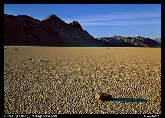 Tracks, moving stone on Racetrack playa and Ubehebe Peak, late afternoon. Death Valley National Park (color)