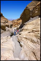 Hikers in narrows, Mosaic canyon. Death Valley National Park, California, USA. (color)