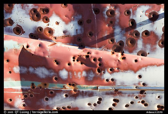 Detail of car with bullet holes near Aguereberry camp, afternoon. Death Valley National Park, California, USA.