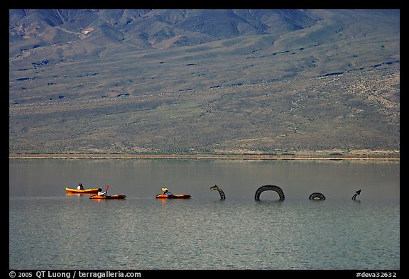 Kayakers approaching the dragon in the rare Manly Lake. Death Valley National Park, California, USA.