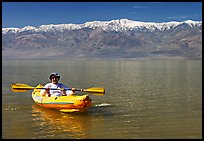 Kayaker padding ephemeral Manly Lake. Death Valley National Park, California, USA. (color)