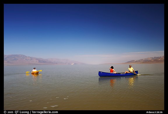 Canoists and kayaker on the flooded floor. Death Valley National Park, California, USA.