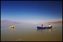 Canoists and kayaker on the flooded floor. Death Valley National Park, California, USA.