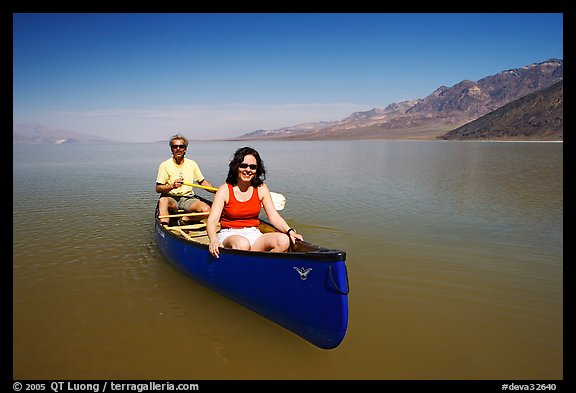 Canoists in rarely formed Manly Lake with Black Mountains in the background. Death Valley National Park, California, USA.