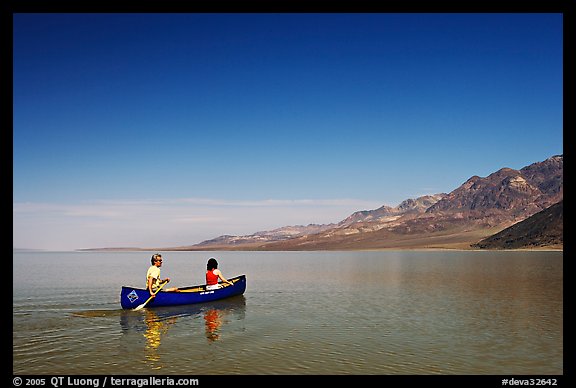 Canoeing on the ephemerald Manly Lake with Black Mountains in the background. Death Valley National Park (color)