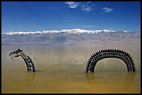 Loch Ness Monster art installation in Manly Lake and Panamint range. Death Valley National Park, California, USA. (color)