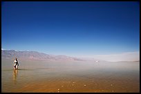 Woman wading in Manly Lake. Death Valley National Park, California, USA.