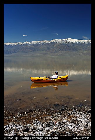 Salt formations, kayaker, and Panamint range. Death Valley National Park, California, USA.