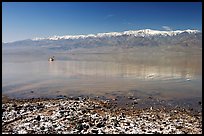 Salt formations, kayaker in a distance, and Panamint range. Death Valley National Park, California, USA. (color)