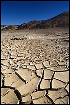 Mud cracks and Funeral mountains. Death Valley National Park, California, USA.