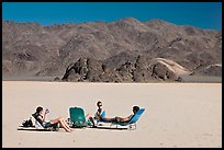 Tourists sunning themselves with beach chairs on the Racetrack. Death Valley National Park ( color)