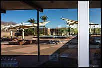 Patio, oasis and mountains, Furnace Creek Visitor Center window reflexion. Death Valley National Park ( color)