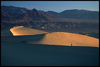 Hiker on ridge, Mesquite Dunes, sunrise. Death Valley National Park ( color)