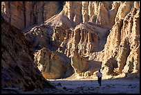 Hikers surrounded by tall walls in Golden Canyon. Death Valley National Park ( color)