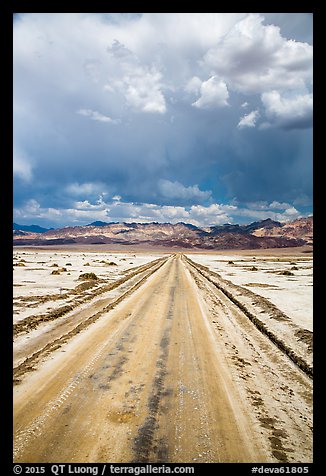 Straight road through Salt Pan. Death Valley National Park, California, USA.