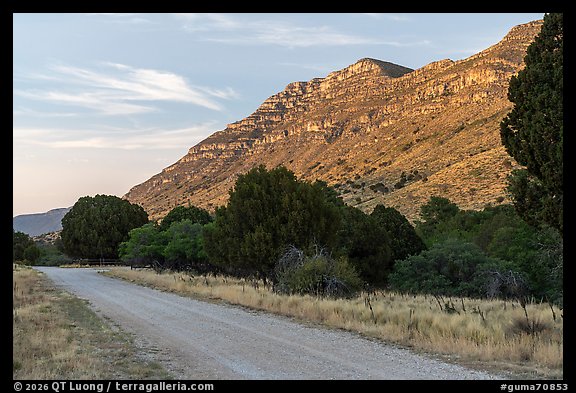 Gravel road at the base of a ridged slope glowing at sunset, Dog Canyon. Guadalupe Mountains National Park (color)