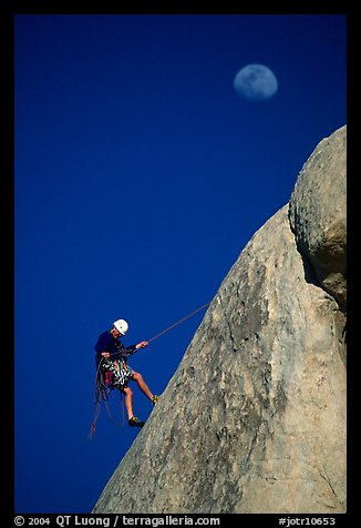 Climber rappelling down with moon. Joshua Tree National Park (color)