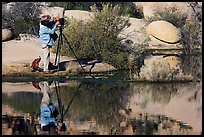 Photographer with large format camera at Barker Dam. Joshua Tree National Park, California, USA.