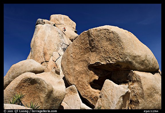 Rocks with climbers in a distance. Joshua Tree National Park, California, USA.