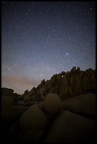 Marble rocks under clear starry sky. Joshua Tree National Park, California, USA.