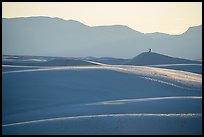 Photographer with tripod on tall dune at sunset. White Sands National Park ( color)