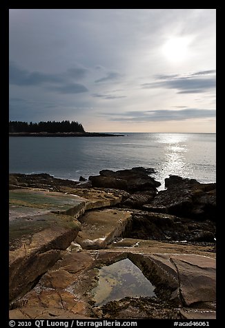 Rock slabs and sun over ocean, Schoodic Peninsula. Acadia National Park, Maine, USA.