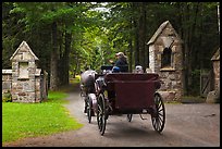 Carriage passing through carriage road gate. Acadia National Park, Maine, USA.