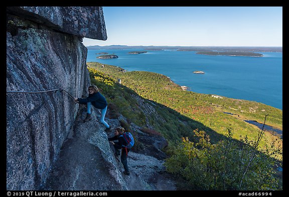Hikers on ledge with handrails, Precipice Trail. Acadia National Park (color)