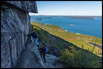 Hikers on ledge with handrails, Precipice Trail. Acadia National Park ( color)