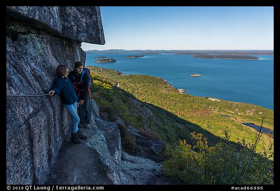 Hikers resting on ledge with handrails. Acadia National Park (color)