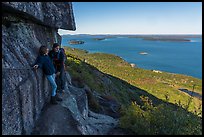 Hikers resting on ledge with handrails. Acadia National Park ( color)