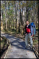 Hiker with backpack standing on boardwalk. Congaree National Park, South Carolina, USA. (color)