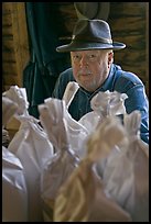 Miller sitting behind bags of cornmeal, North Carolina. Great Smoky Mountains National Park ( color)