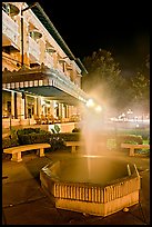 Fountain with thermal steam outside Fordyce Bath at night. Hot Springs National Park, Arkansas, USA.